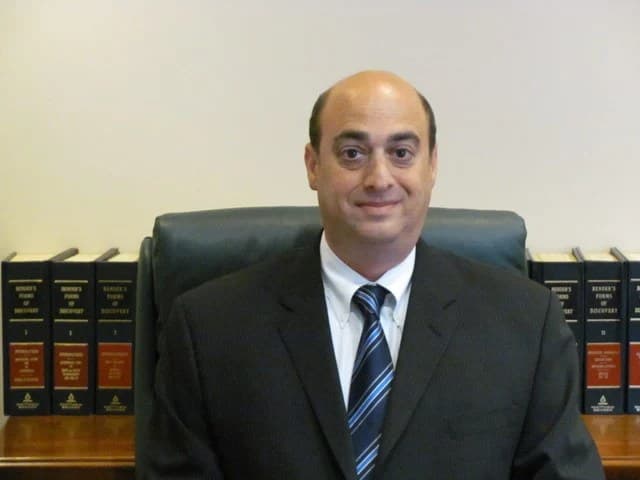 Doug Dolfman at his desk, 3rd generation criminal defense attorney